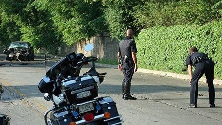 Two police officers investigating a crash